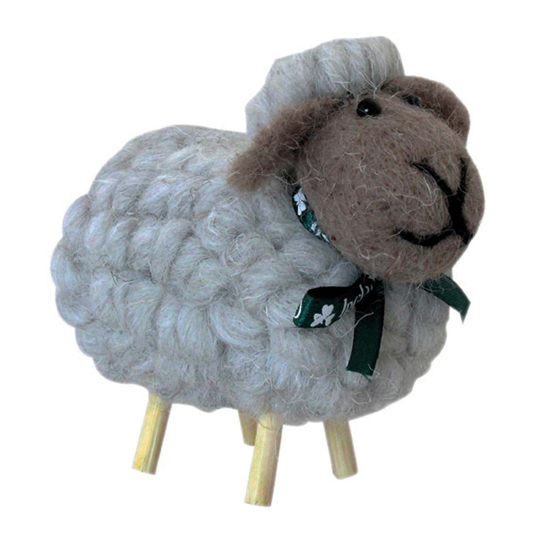 Irish style grey cotton sheep ornament with a brown face and short wooden legs tied with a green ribbon.