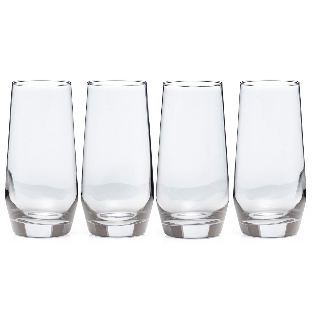 Four empty clear tall drinking glasses arranged in a row