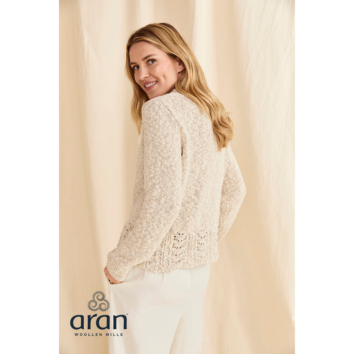Back view of the cream Arawn cotton linen crew sweater showing lace hem detail.