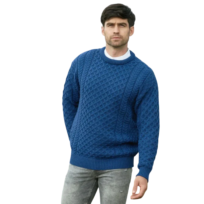Male model wearing a blue cable knit Aran crew neck jumper