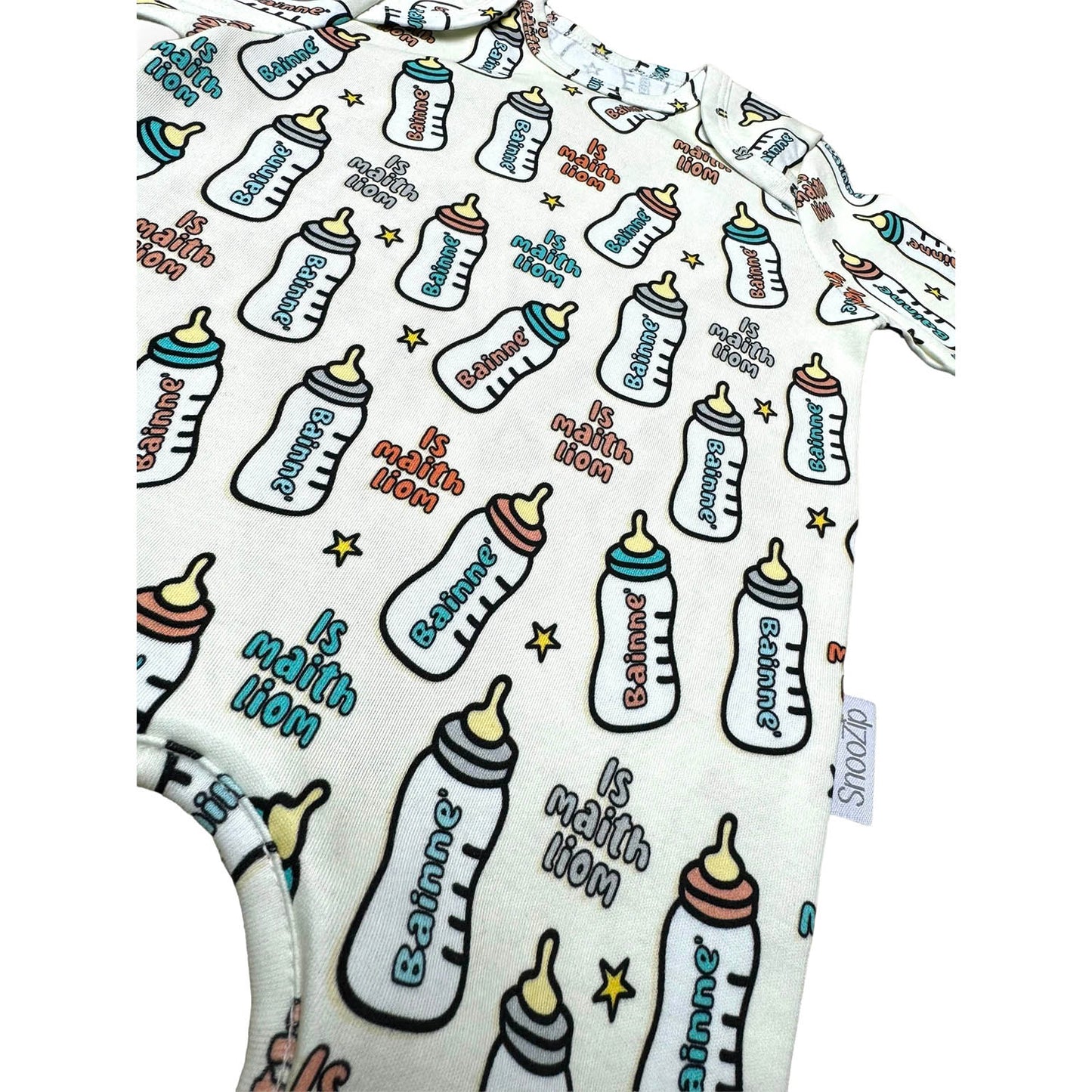 Allover bottle print on a Snoozip Bainne baby onesie with aqua cuffs and a small tag