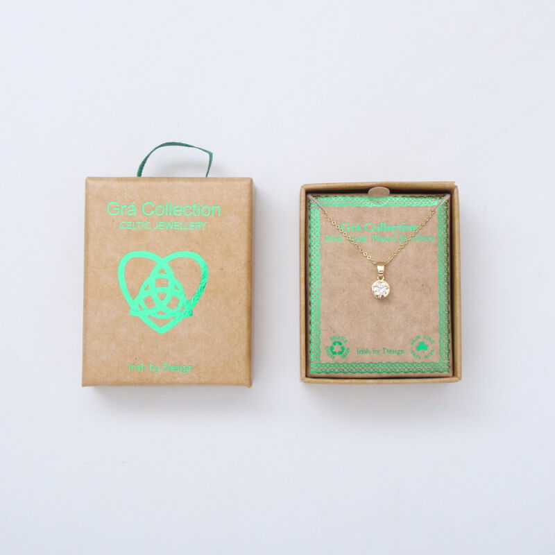 Gold pendant necklace with clear stone in brown Celtic jewelry box