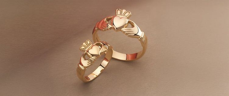 Two gold claddagh rings