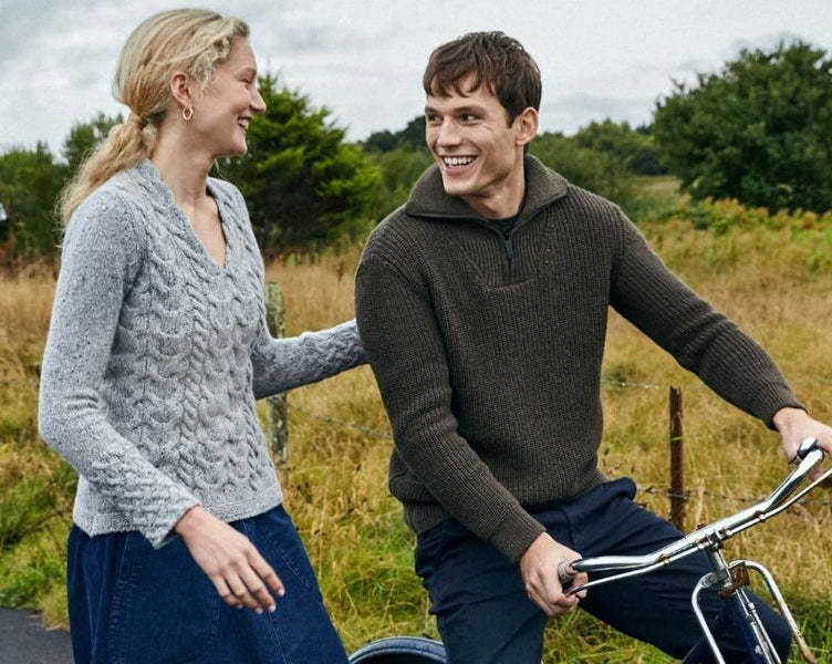 Man riding a bag with a women wearing Aran Sweaters