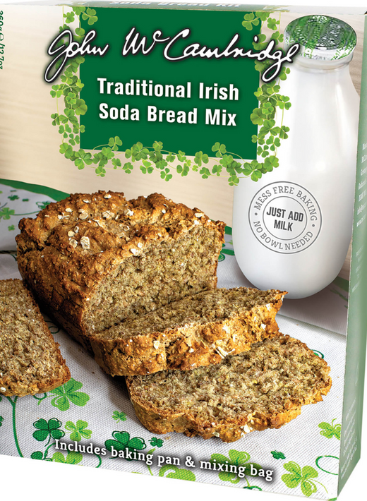 Sliced traditional Irish soda bread loaf on shamrock-patterned cloth