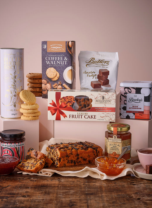 Irish Afternoon Tea Gift Basket featuring biscuits, snacks, jam, and a bottle of red wine.