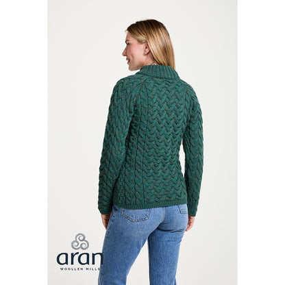 Back view of a model wearing a green Knightstown Merino Aran Crew Sweater showing the cable knit pattern.