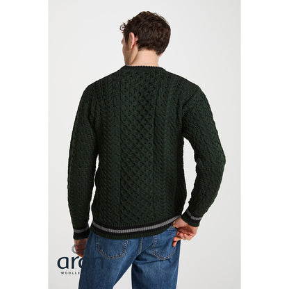 Back view of male model wearing Inishbeg Stripe Crewneck Merino Green Aran Sweater showing cable knit and striped hem