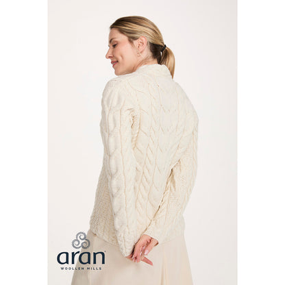 Back view of cream cable knit Merino V-neck sweater on model
