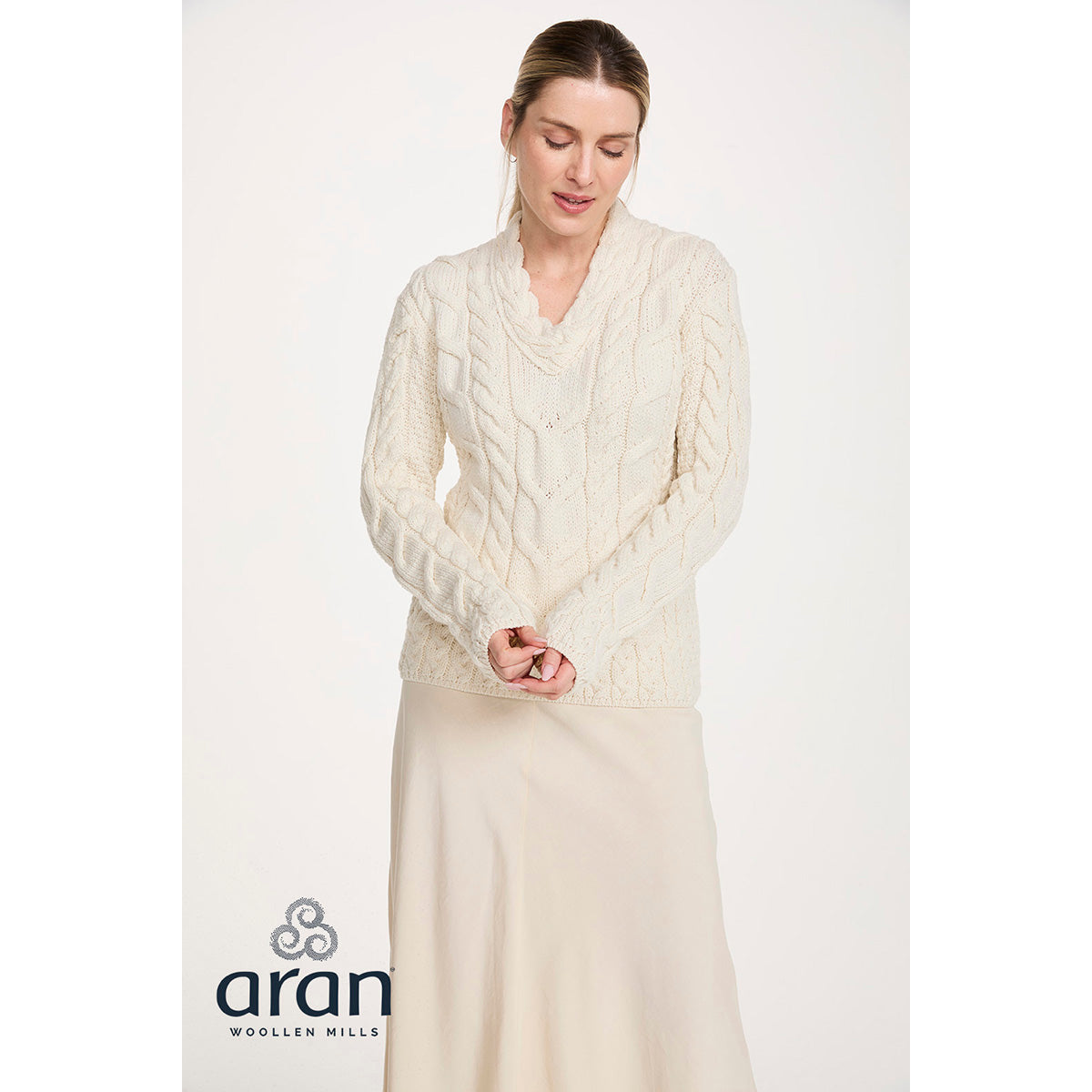 Cream cable knit Merino V-neck sweater worn by a model