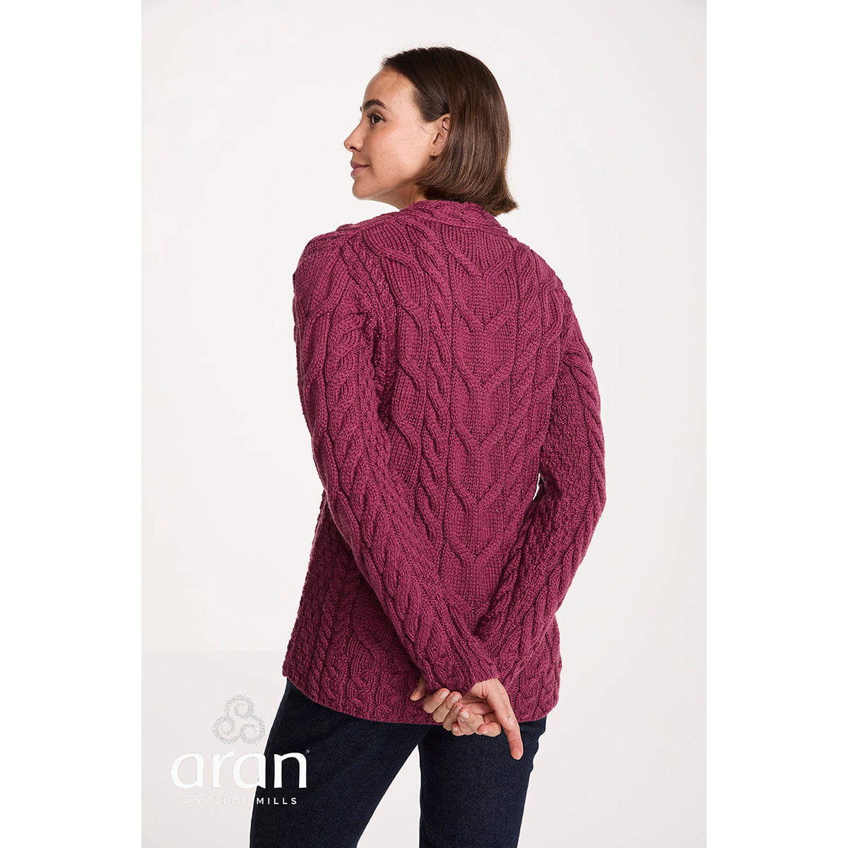 Model seen from the back in a magenta cable knit Tralee V-Neck Supersoft Merino Sweater showing the relaxed fit
