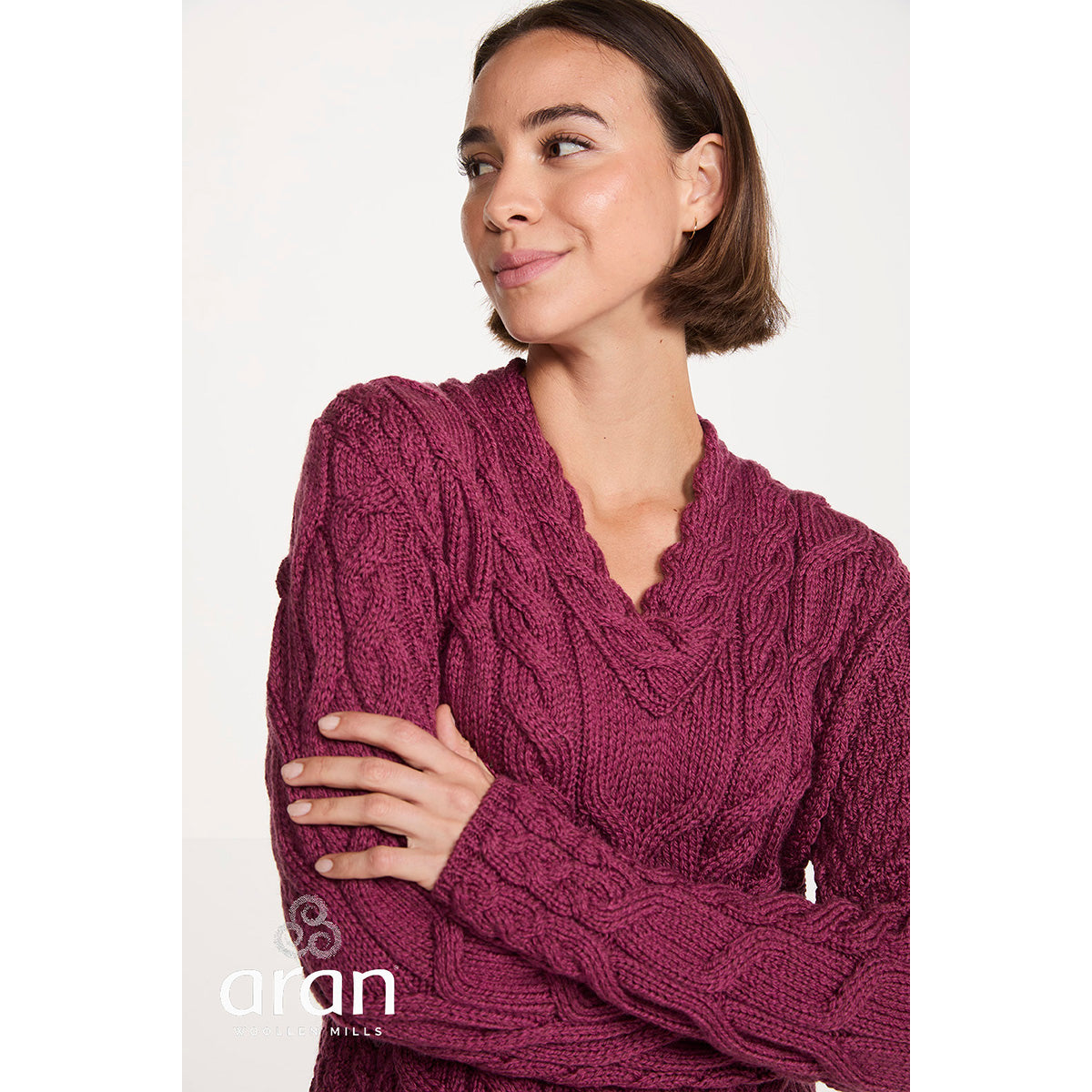 Close up of magenta Tralee V-Neck Supersoft Merino Sweater showing chunky cable knit texture