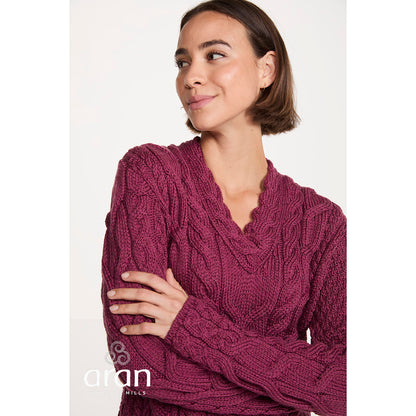 Close up of magenta Tralee V-Neck Supersoft Merino Sweater showing chunky cable knit texture