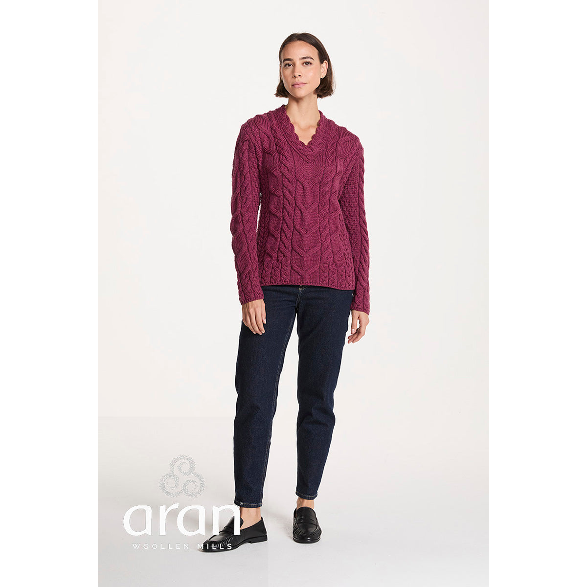 Model wearing magenta Tralee V-Neck Supersoft Merino Sweater with dark jeans and black loafers