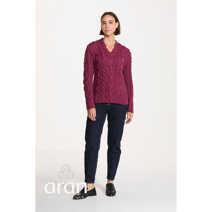 Model wearing magenta Tralee V-Neck Supersoft Merino Sweater with dark jeans and black loafers