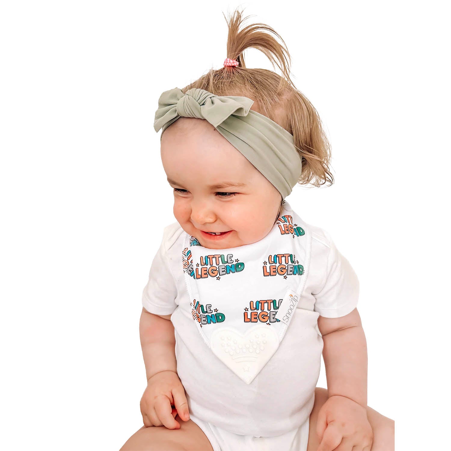 Baby wearing a Snoozip Little Legend teething bib with a heart shaped silicone teether