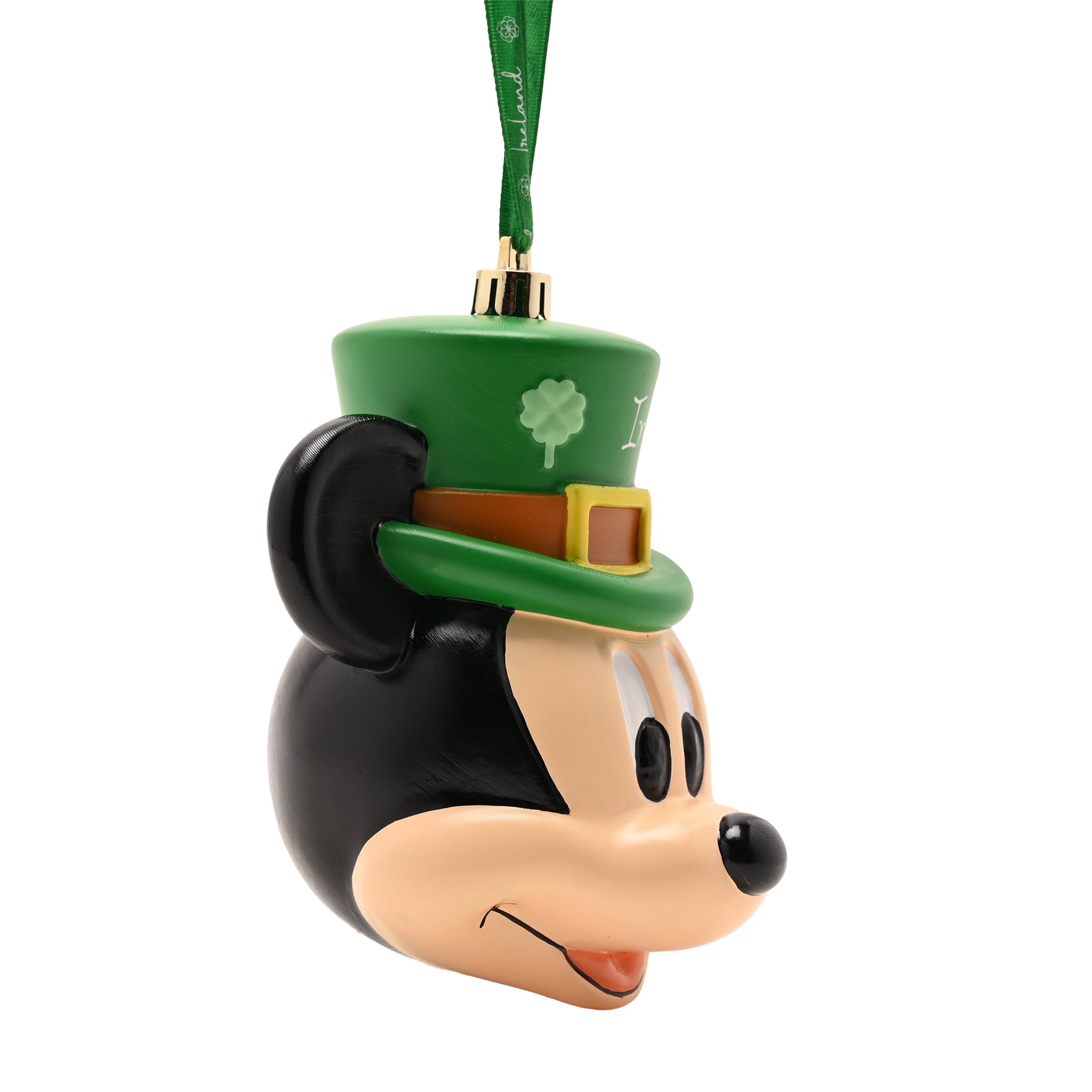 Side view of Mickey Mouse head bauble showing green leprechaun hat with brown band and yellow buckle, hanging from a green ribbon.