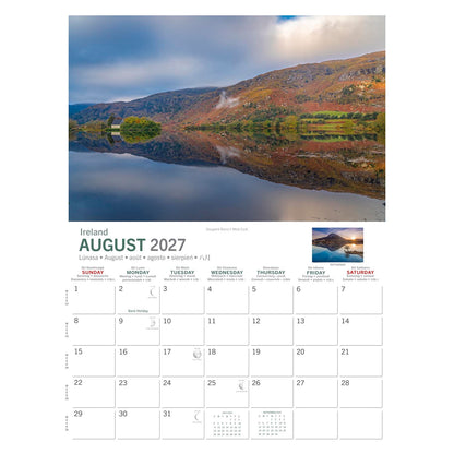 Landscape page from Wild Ireland Calendar 2027 depicting a calm lake with hills and a calendar grid below.