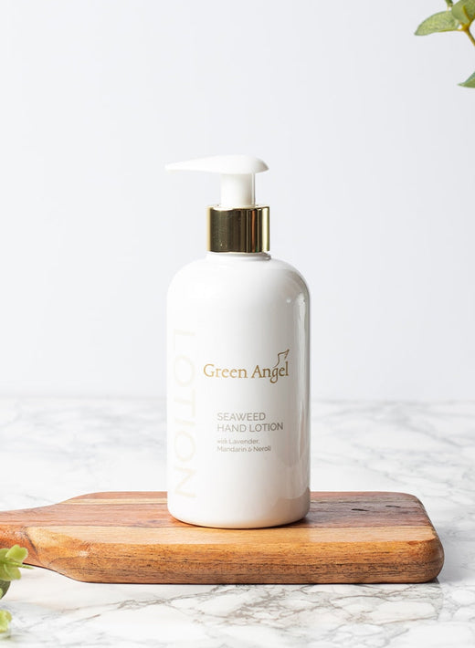 Green Angel Seaweed Hand Lotion bottle with pump on a wooden board