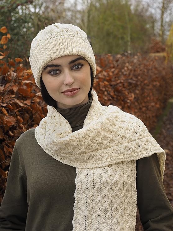 Woman outdoors wearing natural white merino wool honeycomb hat and matching scarf.