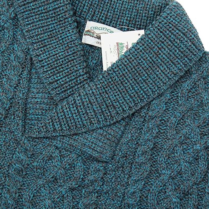 Close-up of teal cable knit sweater collar with visible tags