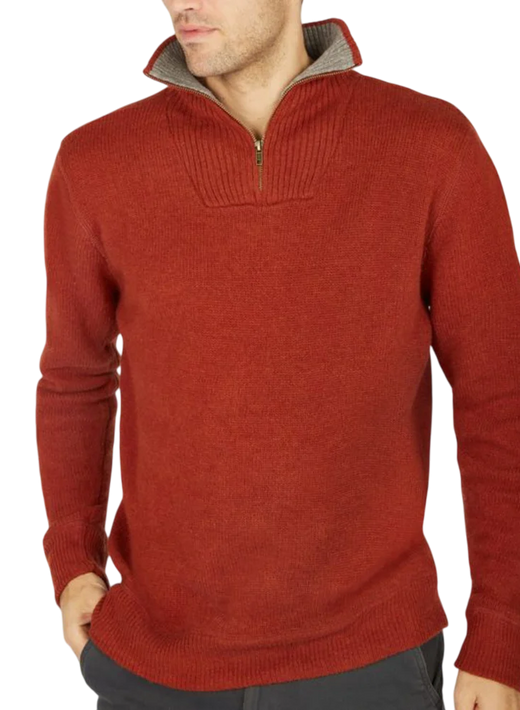 Man wearing a rust-colored quarter-zip sweater with hands in pockets