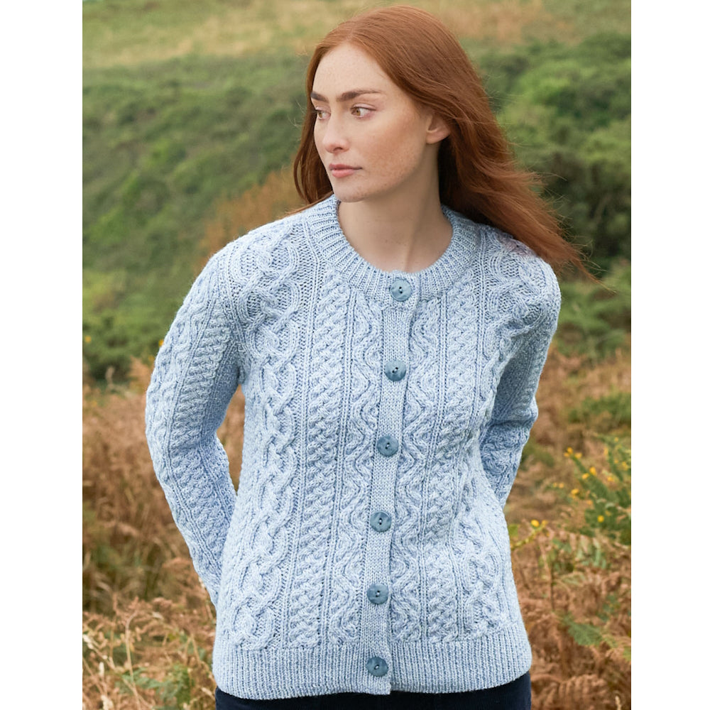 Front view of the model in the Ladies Tramore Ice Marl Aran cardigan with button front outdoors.