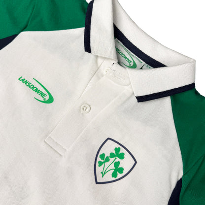Close up of Lansdowne Ireland kids polo shirt with white body green sleeves navy trimmed collar and a shield crest on the chest
