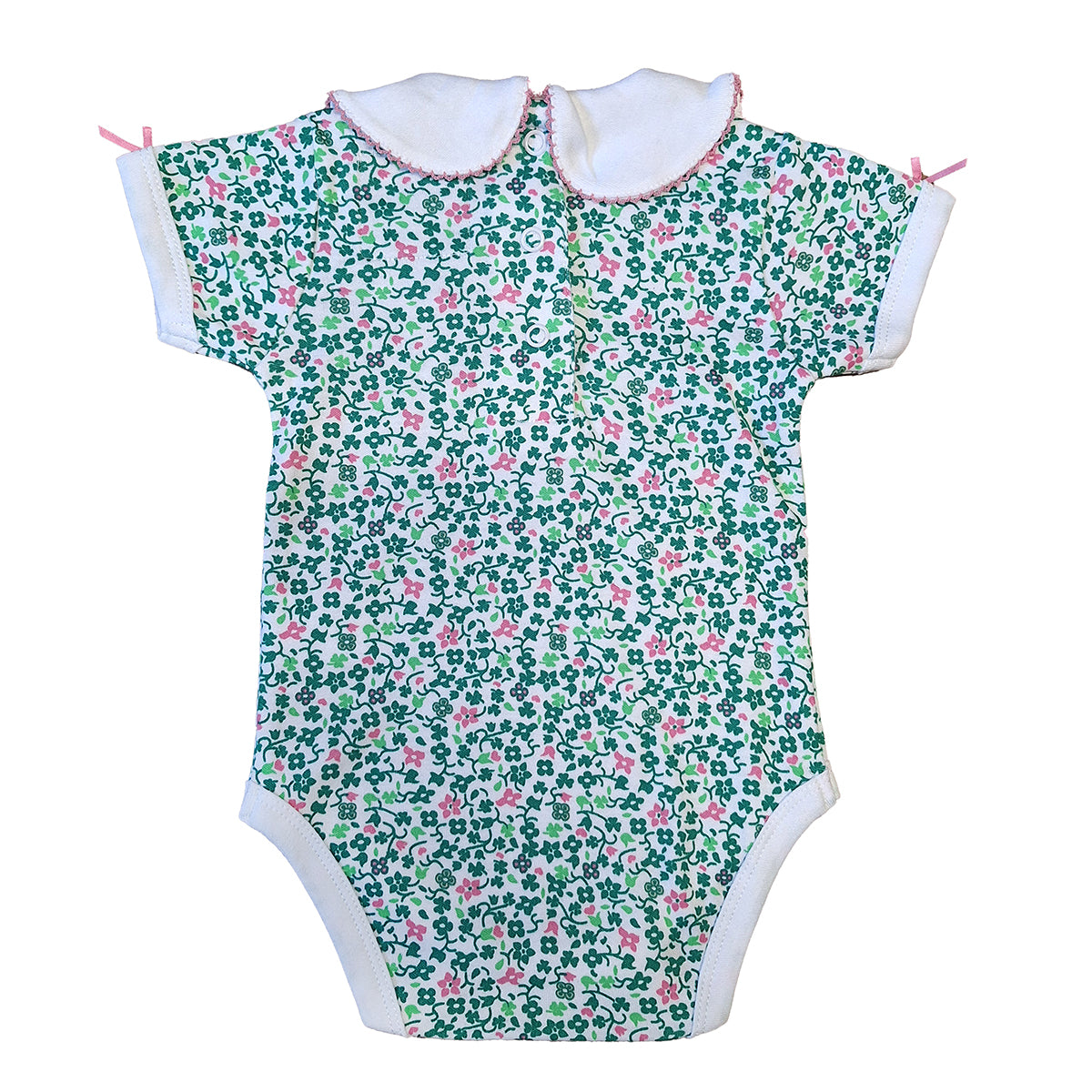 White baby vest with an all over green shamrock and pink floral print and a white collar