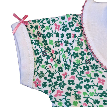 Close-up of a sleeve edge with a pink ribbon bow on the printed baby vest