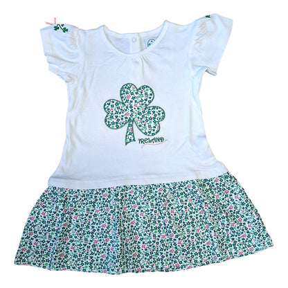 White kids dress with a shamrock applique on the chest and a floral printed frill skirt