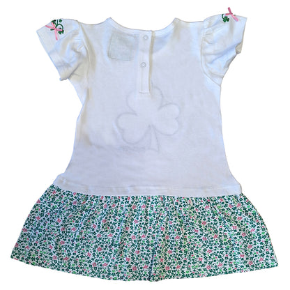 Back view of white Shamrock Applique Kids Frill Dress showing a back placket with snaps and a floral printed skirt.