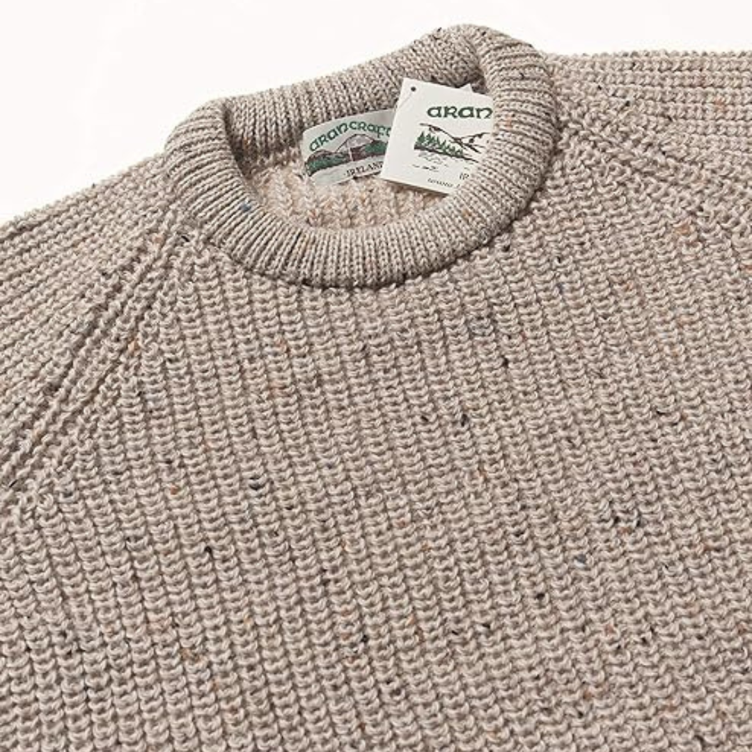Beige fisherman ribbed Aran sweater neckline with brand labels visible
