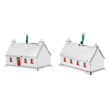 Pair of silver Thatched Cottage keepsake decorations with red window accents and green ribbons for hanging.