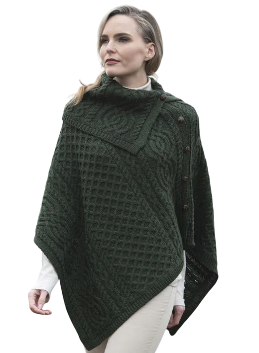 Woman in dark green textured buttoned cowl neck poncho with a diagonal knit pattern