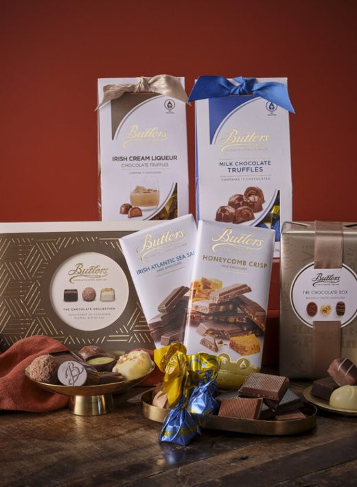 Irish Chocolate Treats Gift Basket with Butlers chocolate boxes and truffles on a rustic wooden surface.