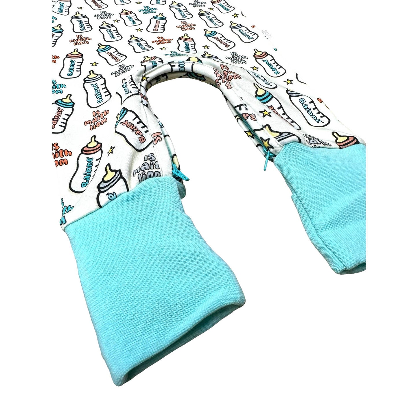 Close-up of the onesie sleeve showing turquoise cuff and allover bottle print