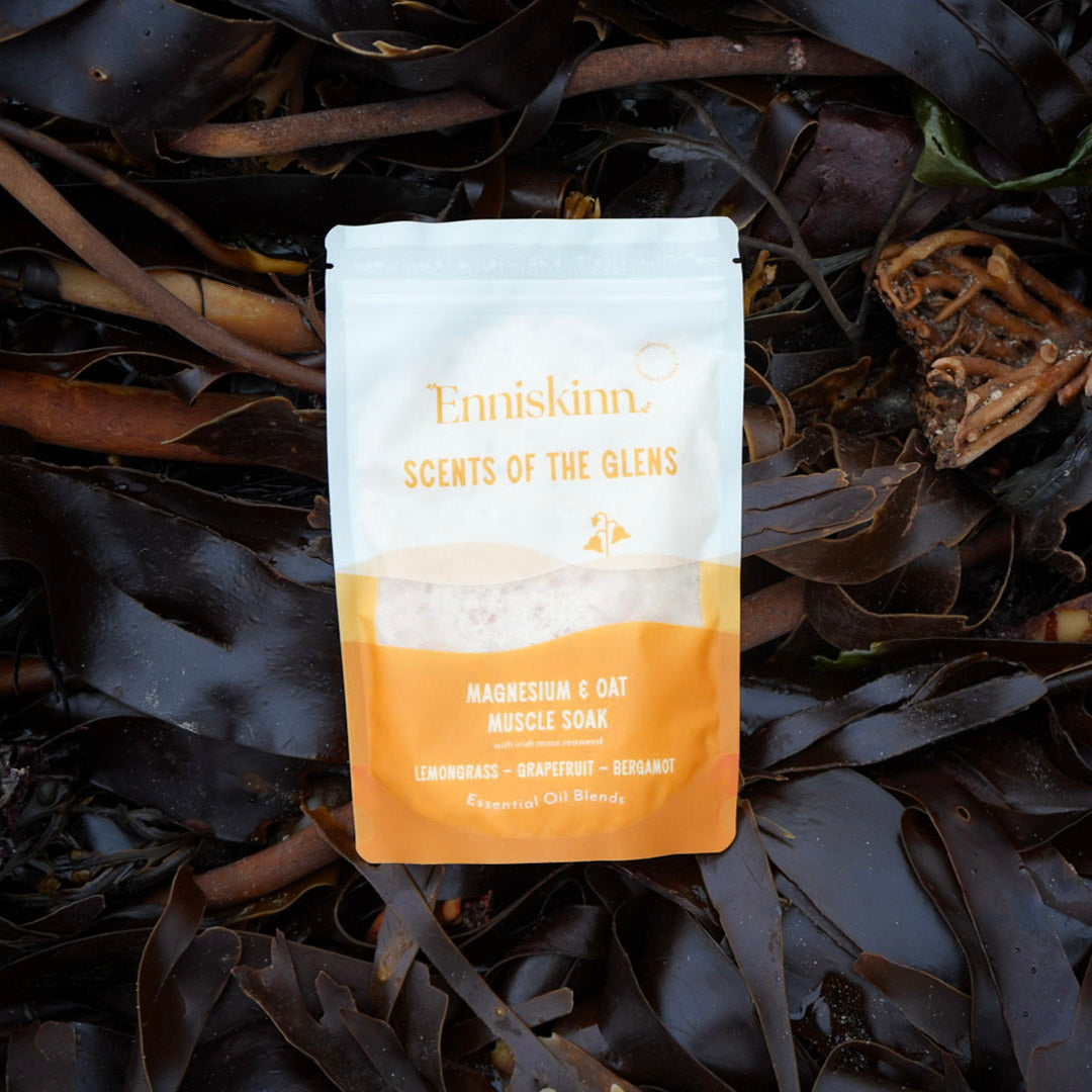 Scents of the Glens Magnesium and Oat Muscle Soak pouch against dark seaweed background.