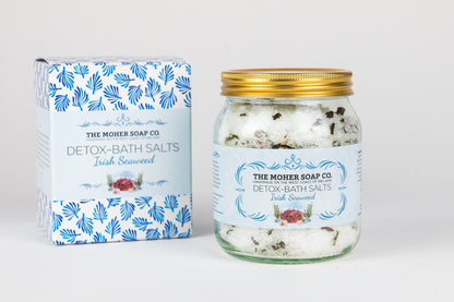 The Moher Soap Co Irish Seaweed Detox Bath Salts jar with a gold lid beside a blue patterned box.