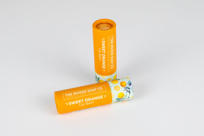 Sweet Orange Lip Balm from The Moher Soap Co with bright orange tube and a citrus patterned cap.