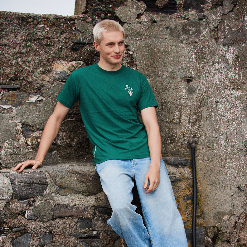 Model wearing a green Guinness Spring Ireland T Shirt with a small white logo on the chest