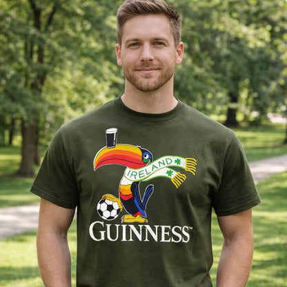 Man wearing a Guinness Bottle Green Football Toucan T-Shirt outdoors in a park