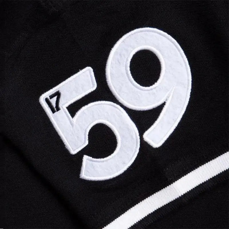 Close up of black Guinness polo shirt fabric with white embroidered 59.