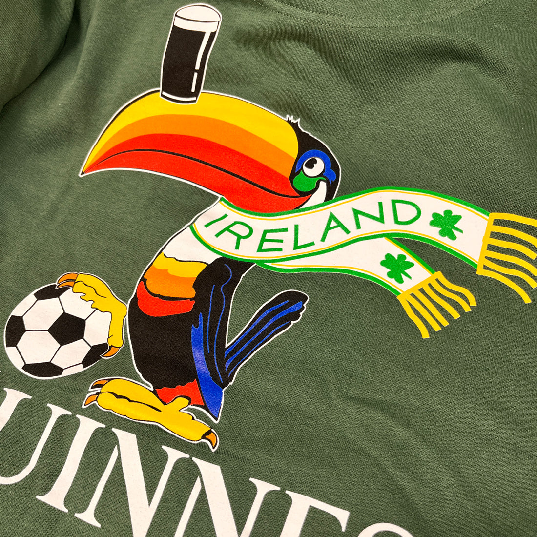Colorful toucan football graphic on bottle green hoodie with Ireland banner