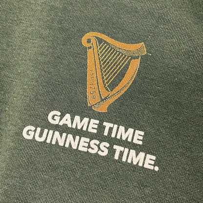 Gold harp logo with GAME TIME GUINNESS TIME text on green fabric
