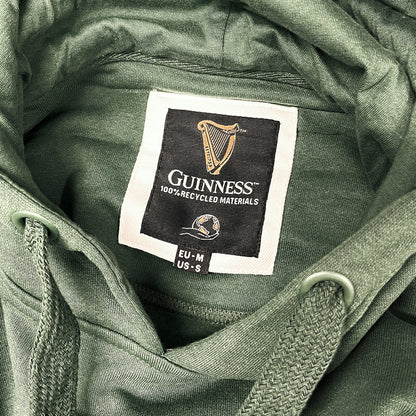 Guinness label inside a green hoodie showing 100% recycled materials
