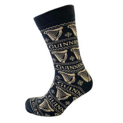 Close up of navy Guinness Harp socks with beige harp motifs wrapping around