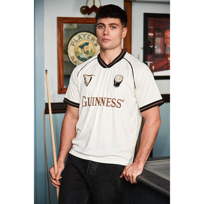 Model wearing cream Guinness Retro Pint Jersey with large Guinness text across the chest.