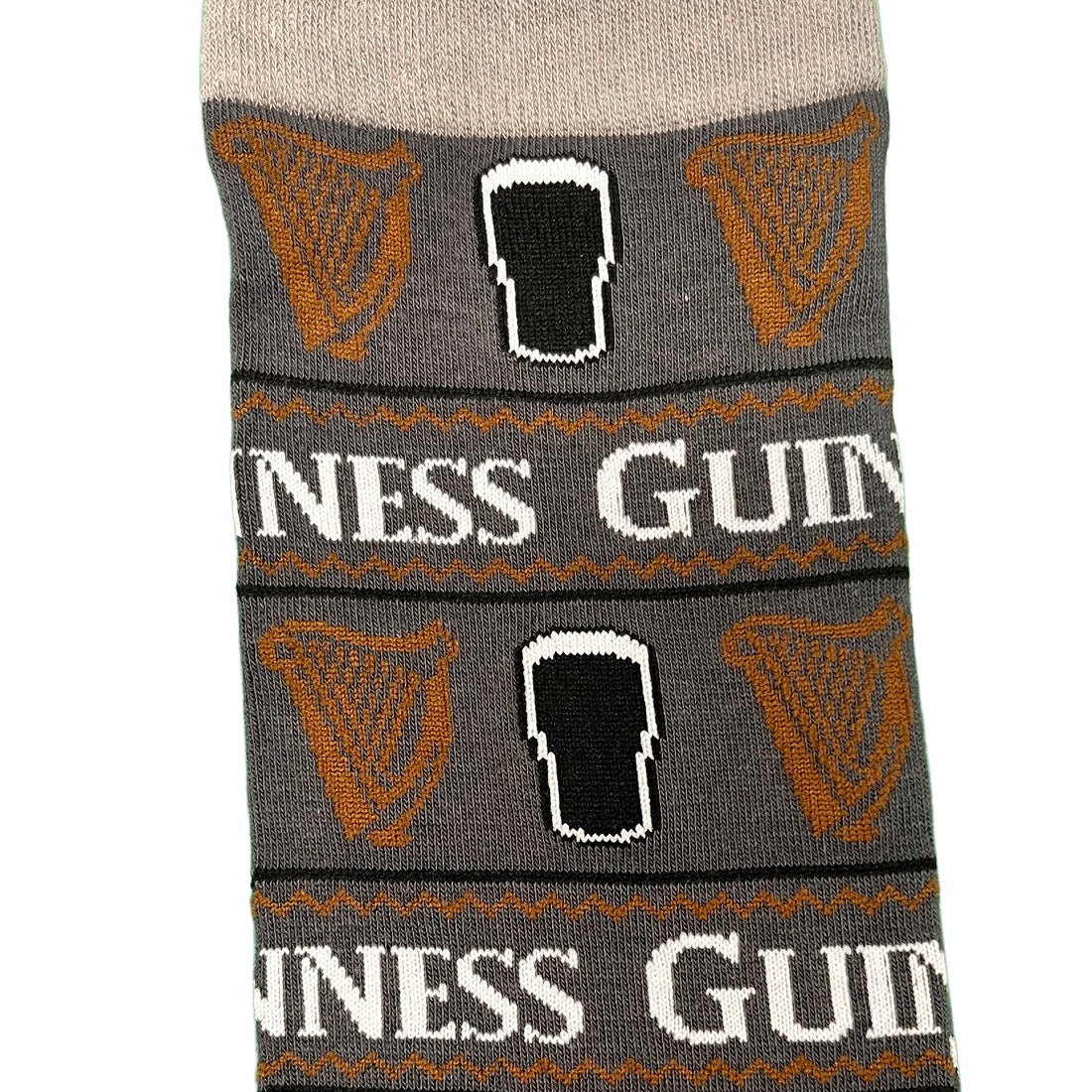 Section of the grey Guinness All Over Print Pint Sock showing orange harps and GUINNESS text around the band