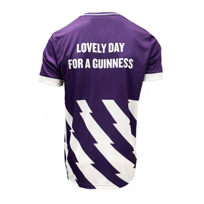 Back view of purple Guinness Premier League football top with the white slogan Lovely Day For A Guinness and diagonal white pattern.